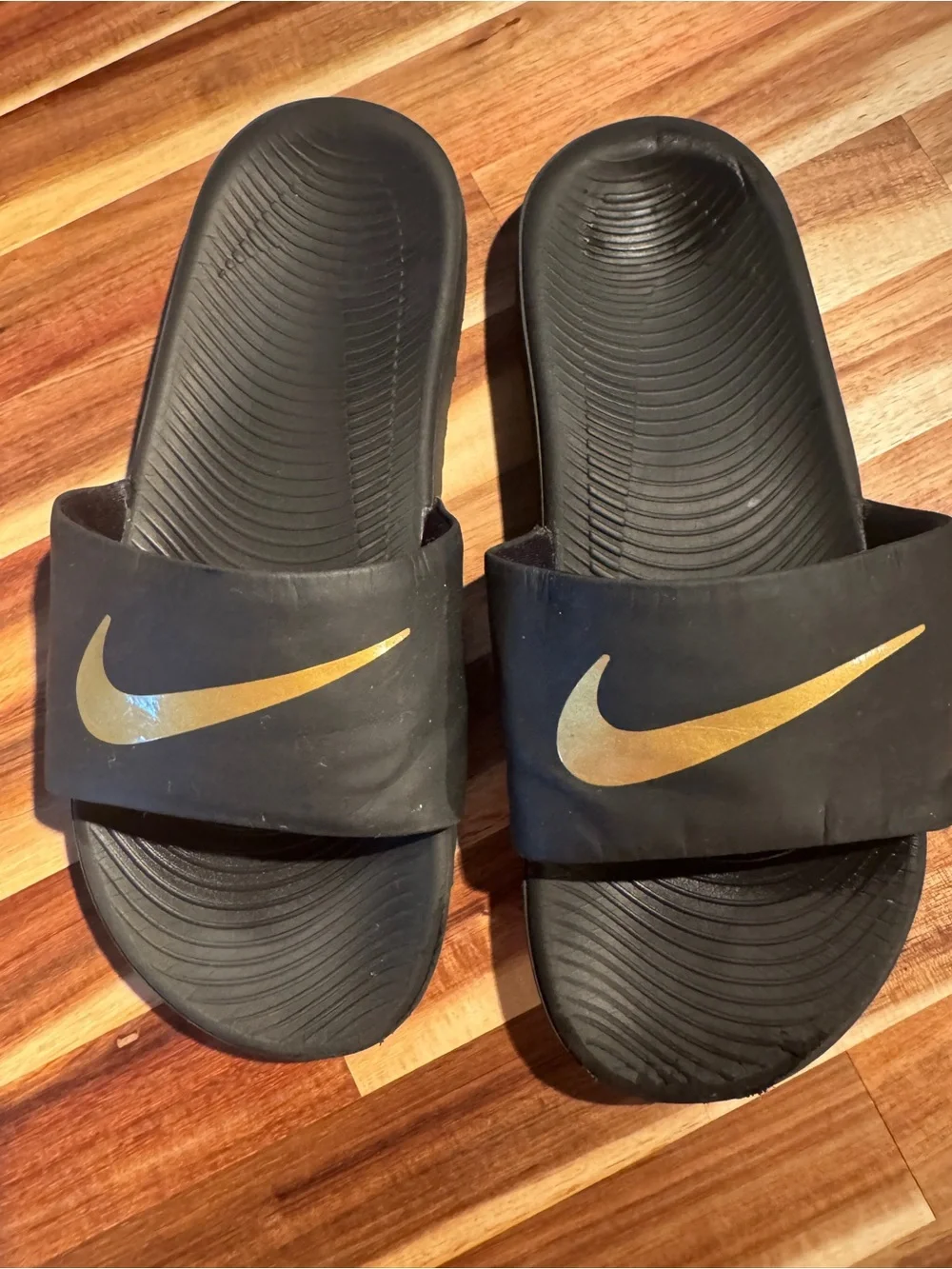 Nike Black Slide Sandals with Gold Swoosh - Kids